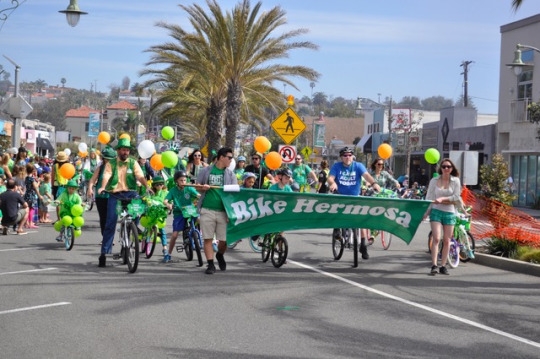 A group of bikers bike down Pier Avenue with their bikes decorated for St. Patrick’s Day. The parade is 7 blocks total, starting at the city hall and then going down Pier Avenue. 