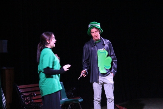 (from left) Junior Cara Noble and senior Henry Johnson perform their St. Patrick’s Day skit for Drama 1 called the Irish Mafia on Wednesday during PM office hours in the drama room. The drama 1 class had been working on these for one week and the performances were open for everyone to watch. 