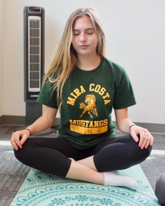 Sophomore Katherine Yollin rests in easy pose as she practices various breathing techniques at the end of Ms. Cross’s fourth period yoga class. The class learned a total of three new meditations.