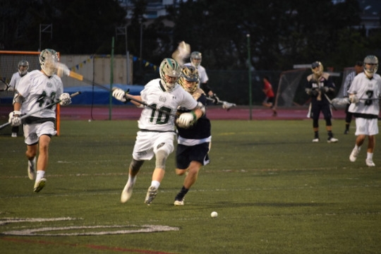 Freshman varsity lacrosse player, Cole Garvey outruns his opponent, in attempt to pick up the ground ball. Garvey fronted his opponent in order to get a better body position, and therefore allowed him to pick up the ground ball at a better angle.