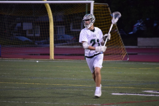 Sophomore Max Geoghegan cradles the ball in his offensive zone, lifting his head to look for an open teammate. In order to prevent the ball from falling out of a player’s stick, they must cradle their stick back and forth across their body.