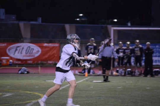 Senior Johnathan Packer raises his stick and yells for the ball because he is wide open. Once the ball was passed to him, he looked for an open teammate or an open lane to drive to goal.