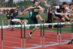 Sophomore Lucas Hobbs successfully jumps over a hurdle in his event on Saturday. He was neck and neck with a Peninsula and a South Torrance opponent throughout his race.
