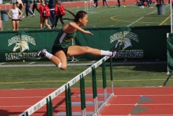 Junior Tessa Chan jumps a hurdle in her race on Saturday at Waller Stadium. Chan cleared every hurdle she jumped in this Girls Varsity Hurdle Event early on Saturday Morning.