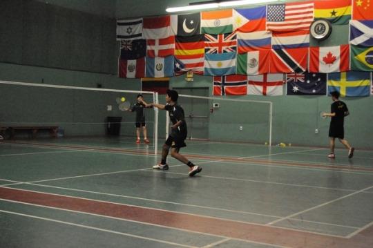 Freshman Rohil Dave moves forward towards the birdie while warming up for his match. The Mira Costa Badminton team played in this tournament on March 18th at the Manhattan Beach Badminton 