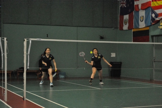 Junior Audrey Kim uses her badminton racket to return the birdie to the opposing side. Audrey Kim played with partner Audrey Mei in a doubles match following their lunch break on Saturday. 