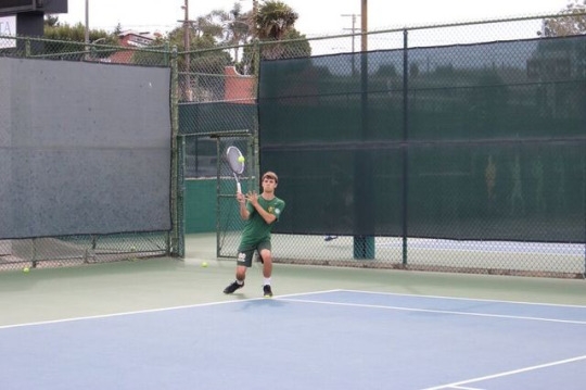 Mira Costa Junior Dylan Sutro hits the ball back to his teammate during a warmup for the game against Arcadia Boys Varsity. Sutro made many offensive and defensive plays that aided the Mira Costa Boys.