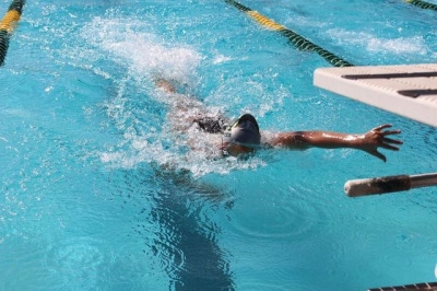Freshman Leigh Lyter swims in the 100 meter freestyle for Varsity in the South Bay Invitational meet. Lyter swam in multiple events and swam fast enough to gain points for Costa.