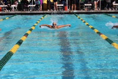 Sophomore Camille Lyter swims the 100 meter butterfly for Varsity after getting first in her event for Prelims. Lyter went on to get third in her event to help Costa.