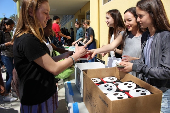 Sophomore Mary Taylor buys Panda Express from members of the Dance Team at Club Day during lunch on Wednesday. Club Day happens once every quarter and gives clubs a chance to raise money for their club activities.