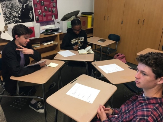 Juniors Kade Barr (left), Brianna Mayweather, and Ryan Pongan work as a group to analyze symbols in The Great Gatsby as part of Mrs .Wachell’s english class in room 43 during first period today.  Students of that class have been reading The Great Gatsby for two weeks now and had finished it last night.