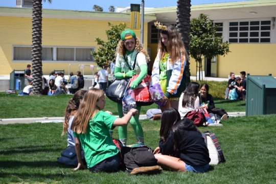 Juniors Georgia Wedbush, running for ASB president, and Keeli Hartley, running for ASB vice president, walk around during lunch, passing out candy to students around campus. Wedbush and Hartley dressed in green and gold, which represented Costa spirit.