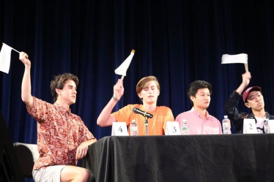  Juniors Tommy Kelleher (right), Noah Geller and Peter Lu raise their flags during the 2017 Scholar Quiz Final Match. Lu’s team was victorious making this the teams third win. 