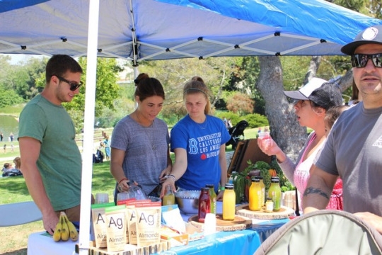Workers at Sunlife explain the different kinds of juices to many people and tell them the different things it helps with in your body. They brought many different samples for people to try including orange juice and many other kinds of juices.