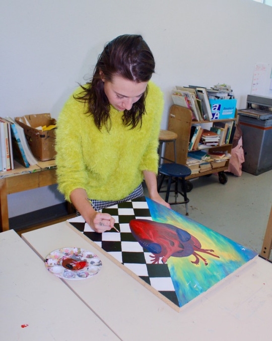 Sophomore Devon McKnight puts a few final touches on her painting at the beginning of lunch in the art room before submitting it to an upcoming art show. She began the project three weeks ago.