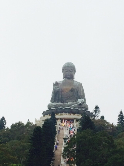The Tian Tan Buddha or “Big Buddha,” sits atop the mountains on Lantau Island, Hong Kong where it is visited by tourists and monks everyday. Here, tourists took the trip up 268 steps to get a closer look at the universal symbol of Harmony between Man and Nature. 