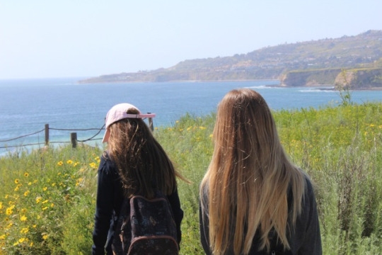 Ettley (left) and Balzer (right) begin their hike down to the tide pools at Trump National Golf Course. The students followed the long trail down to the tide pools that was covered by wildflowers which made it a difficult trail to hike.