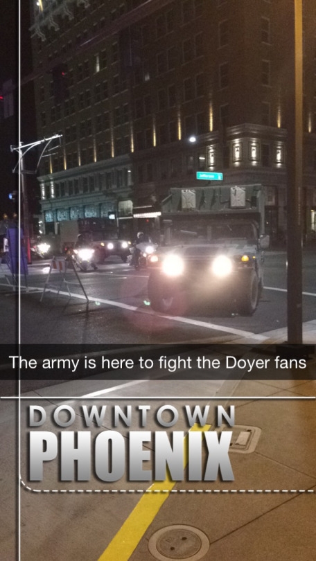 Being a military city, an army jeep drives through downtown Phoenix after the end of the baseball game. I was with my dad walking back to the hotel when I saw this.