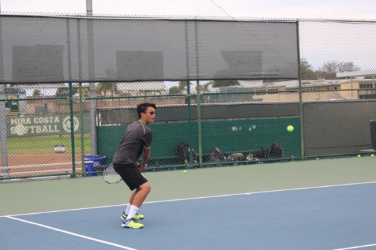 Freshman Charles Zhang receives the ball and returns it to the other side to help his team in the match. Zhang helped his team by gaining a point in his match at practice. 