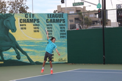 Freshman Kyle Chen serves the ball to the opposing team to have them practice for their match. The F/S team has 12 people on it and all alternate matches at games.