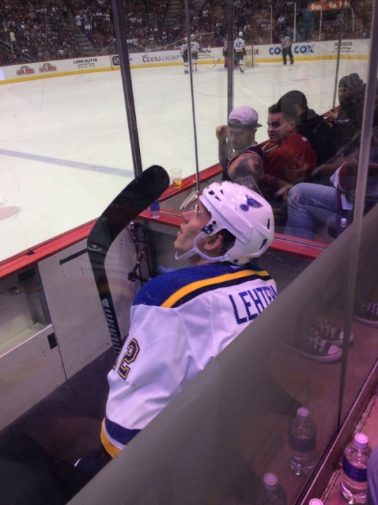 Sitting right behind the glass at the hockey game, we happened to be right behind the benches and penalty boxes as well. A St. Louis Blues player is sitting in the box here serving a 2 minute minor penalty, I don’t remember what for though.