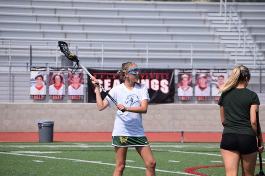 Varsity lacrosse player Amalia Louis catches and cradles the ball during her warm-up in her last Bay League game of the season against Palos Verdes. In Costa’s warm-up the varsity team did passing lanes, shooting, and 3v2 to mentally and physically prepare for their game.