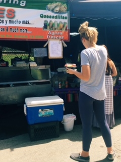 Mira Costa High School student, Ella Nuttall-Smith (freshman), waits in line at a Mexican food booth for their famous lemonade. The Hermosa beach Farmer’s market has provided various amounts of food booths for the customers. 