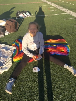  9th grader, Linnea Wee is playing cards while taking a break from walking the track all day. She had her own game to play cards with by herself.