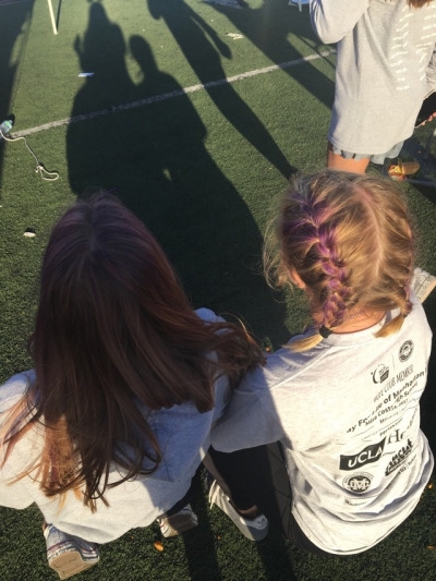 Girls on Team Tumor Kaboomers are all decked out in purple for their team color. They had their hair spray painted, purple beads, purple stickers, purple headbands, and team shirts.