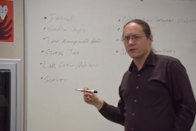 Challenge Success Coach Paul Franz opens up the Monday meeting In the Guidance Conference Room.  Franz wrote down what the SEW Committee had accomplished this year.