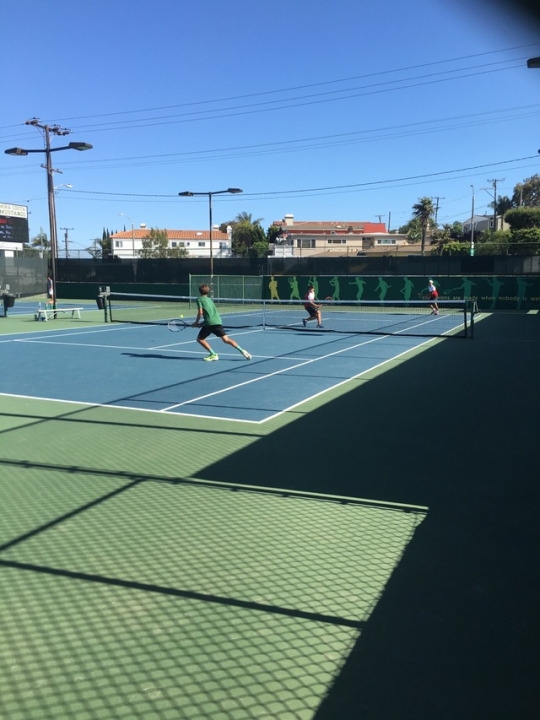  Nick Darrow hitting a backhand volley cross court to win the point with a follow up volley May 2 2017. Nick is known to have one of the best net games on the team.