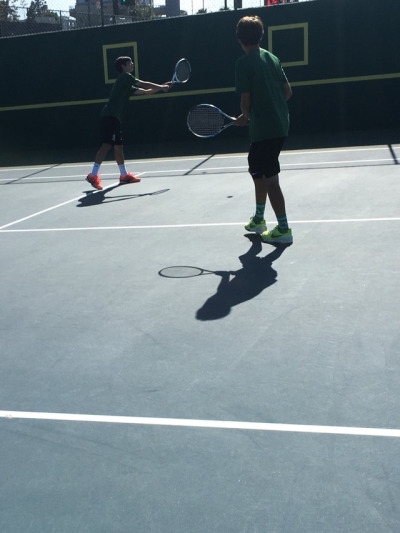 Kyle Chen hitting a backhand volley in their math against PV May 2 2017. They were both at net to get the advantage to win the point.