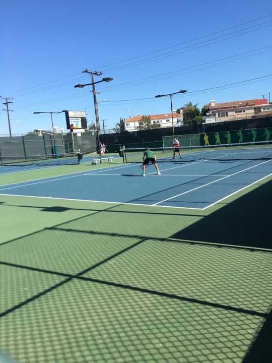 Nick Darrow getting ready to hit a volley to try and win the point for his team. Nick won the point with his powerful volley.