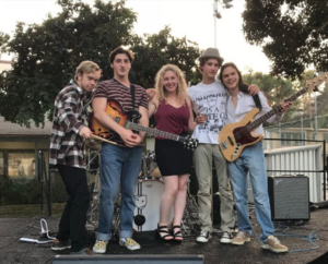 HeartandSouL: (left to right) Seniors Henry Staton, Kira Levin, Jesse Eads, and juniors Cole Fishman and Daniel Dale pose for a picture after playing a set at the hometown fair on Oct. 6. Business Casual has performed around the South Bay for the past two years. Photo Courtesy of Cole Fishman.
